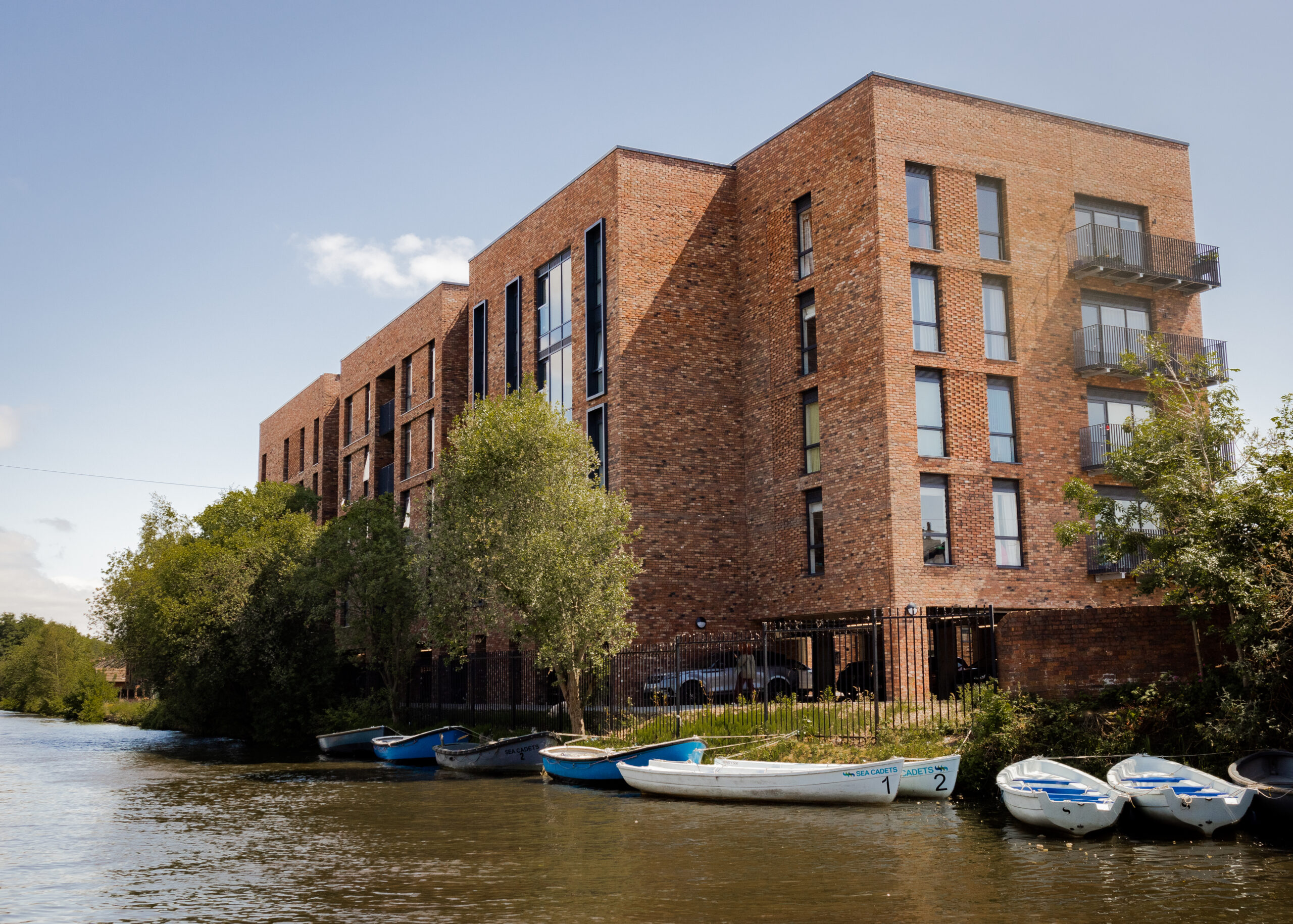 Building view wil canal and boats of The Wharf Residential Development in Altrincham in Manchester